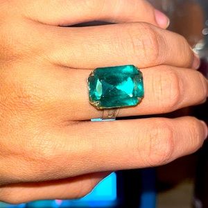 This is an Emerald ring. It is adjustable to fit the size of any of your finger